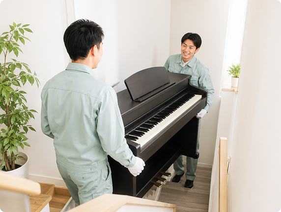 電子ピアノを運搬するスタッフ